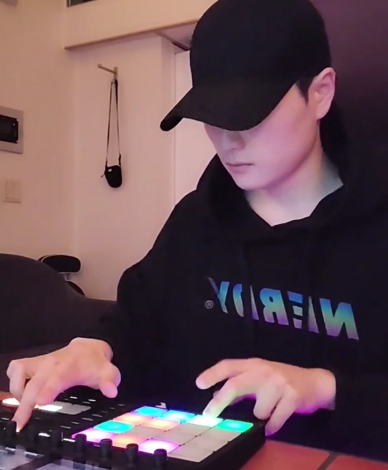 Sungjoon Kim finger drumming on an illuminated pad controller